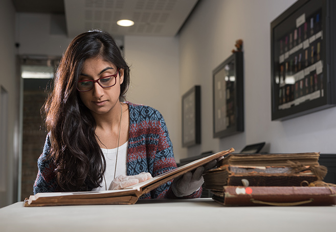 Dr Priya Atwal looking through the museum’s archive. Photo by John Cairns